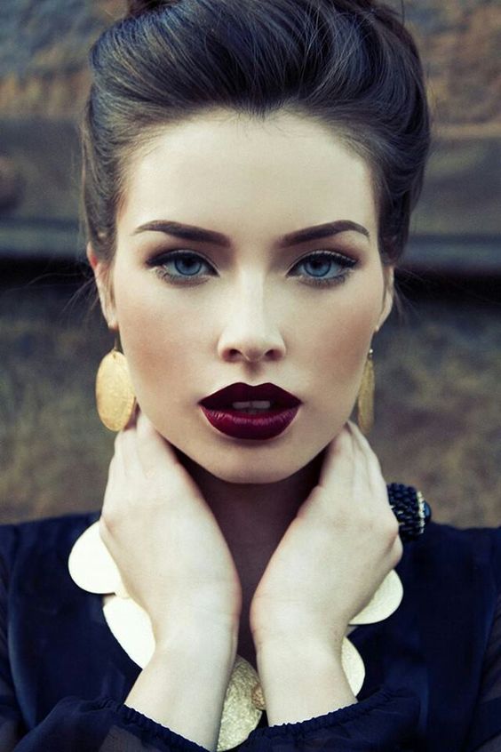 a super dark maroon bridal lip and a gold leaf crown make the bridal look edgy