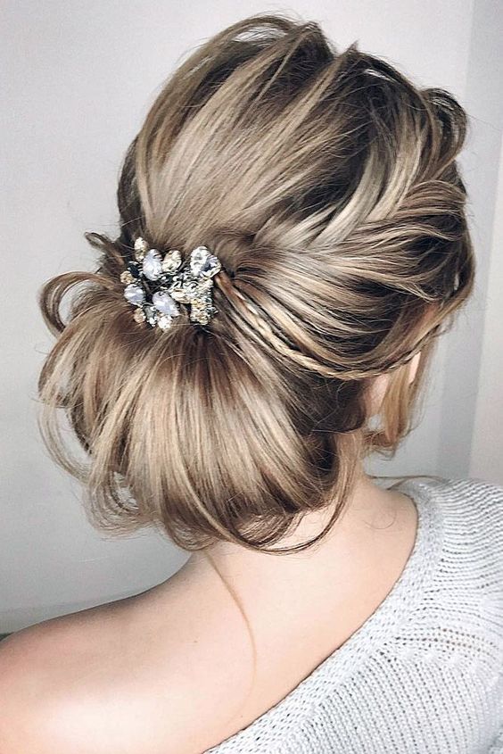 a large French twist chignon with a bump and messy touches for a breathtaking look
