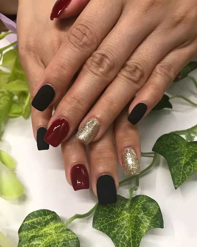 black, gold and maroon nails