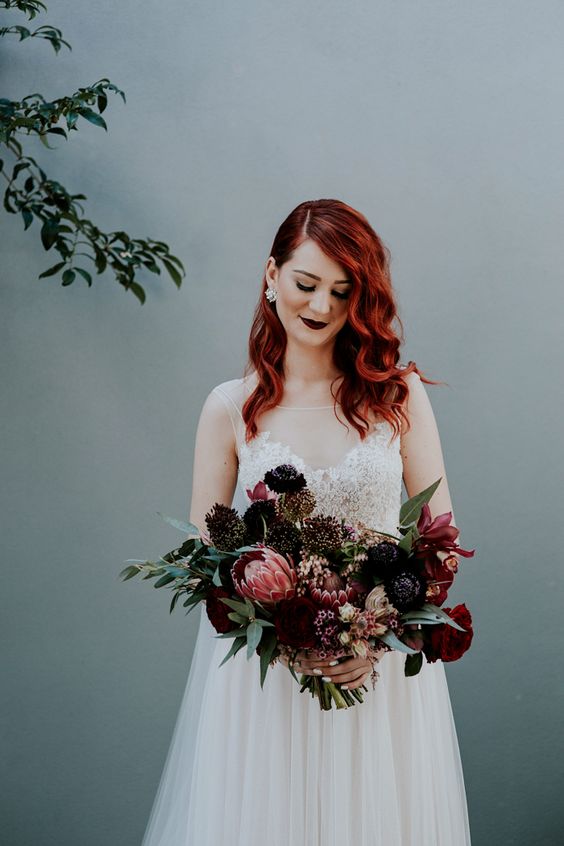 purple smokeys and a dark burgundy bridal lip for a unique and statement look and a crown for a bit of edge