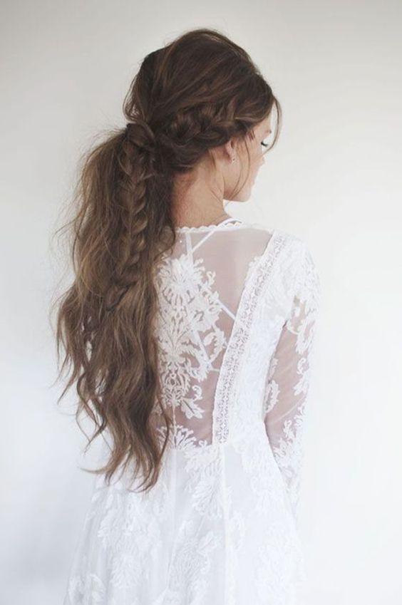 a messy textured and wavy ponytail with some locks down and a twist is a cool idea to rock