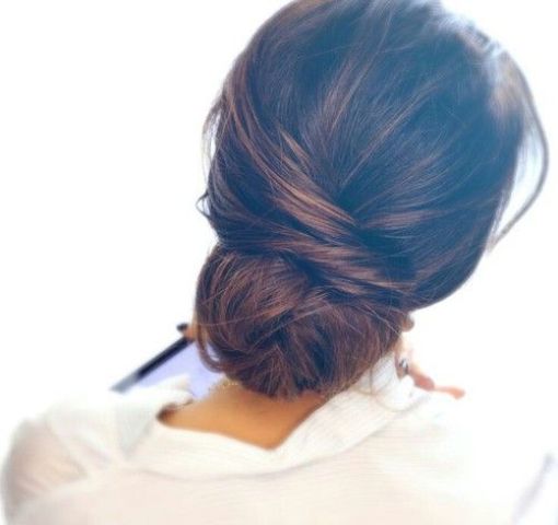 a messy low bun with a bump and some textural hair down plus a rhinestone hairpiece for an effortlessly chic look