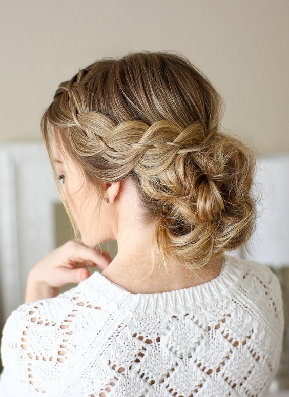 a fishtail French braid with a low bun on long hair is a great and trendy take on a usual low bun