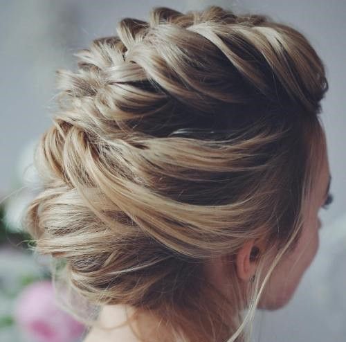 a low updo with a braided halo and some locks down can be worn with long or medium-length hair