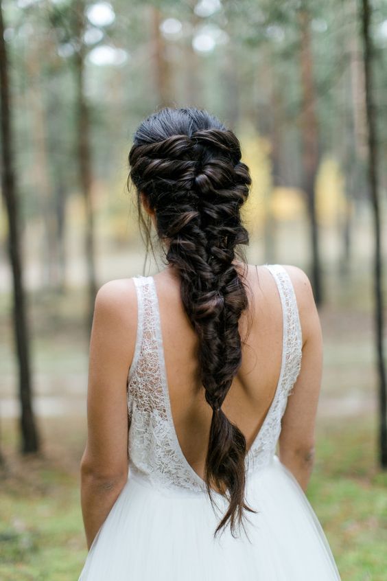 a half updo with a side braid and waves looks very soft and romantic