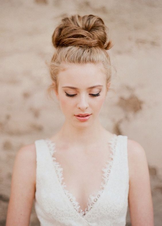 a wavy top knot with a braid on top is ideal to spruce up a traditional bun