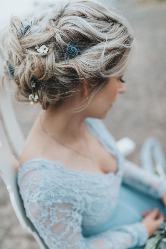 a super messy braided wedding updo with some locks down is a fit for both a minimalist or boho Scandinavian bride