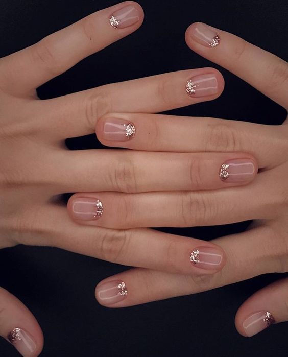 nude nails with tiny rhinestones and a whole accent rhinestone nail for a glitter touch