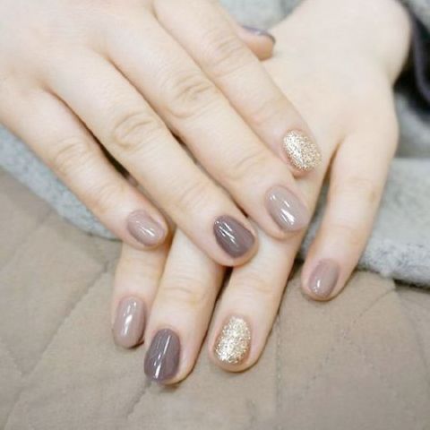 spruce up matte grey nails with a touch of metallic geometric decor to add a shiny detail to your look