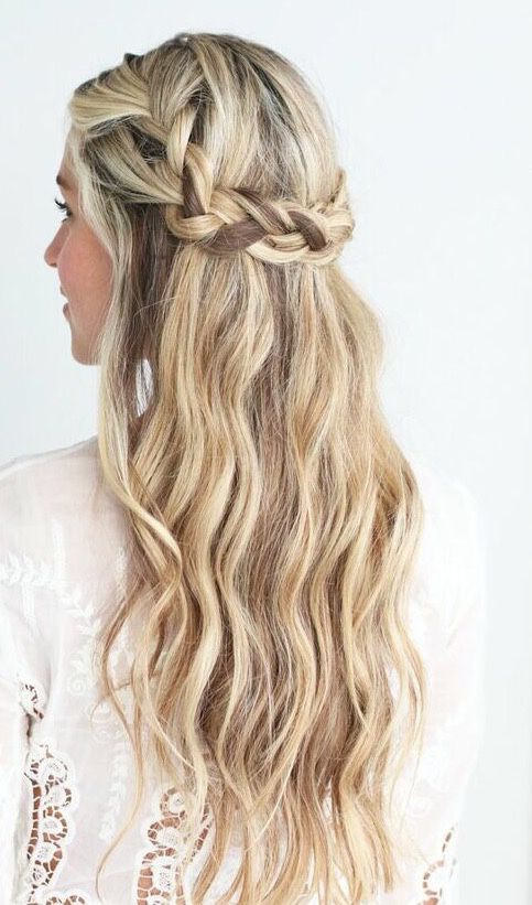 a wavy braided half updo with fresh blooms that fit the wedding bouquet