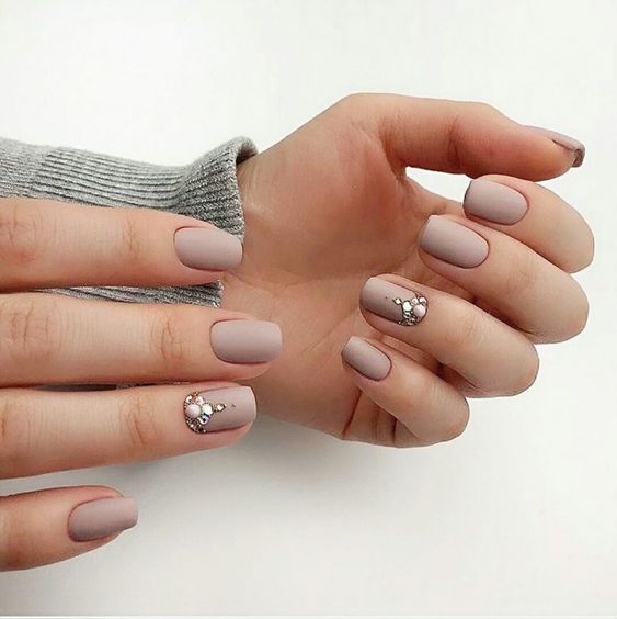 matta neutral nails with gold stickers that will give a shiny and modern feel to your manicure