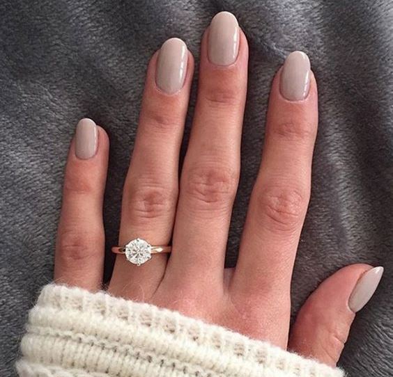 shiny white nails with a large rhinestone on the ring finger is a chic idea for a bride who loves glam