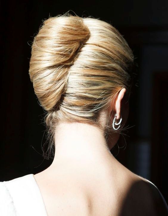a chic French twist updo with a bit of volume on top and some wavy locks down is ultimate elegance