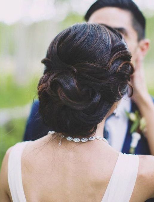 curly bridal updo with a rhinestone and gold hair vine as a trendy accessory