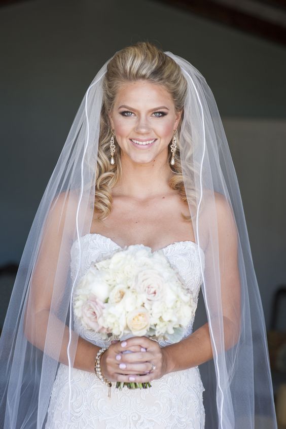 curly half updo with an ivory cathedral veil