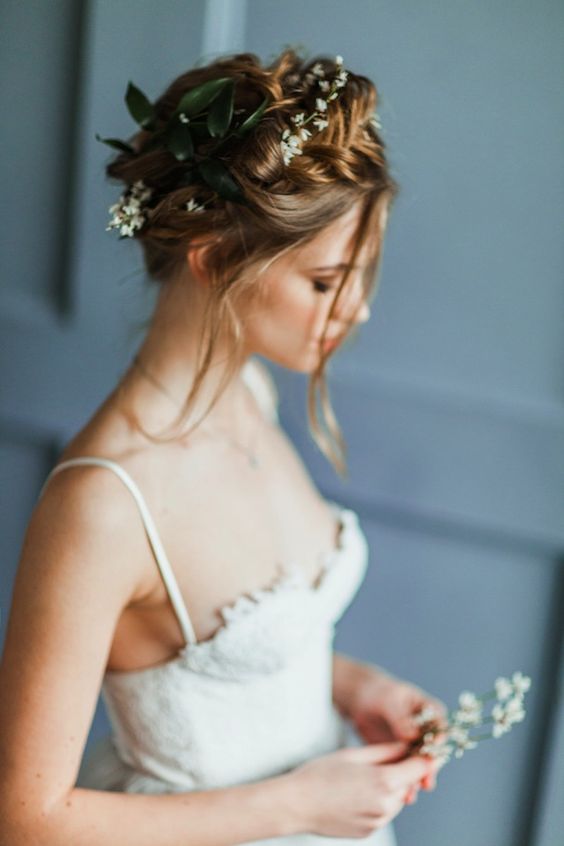 braided updo with fresh flowers and greenery