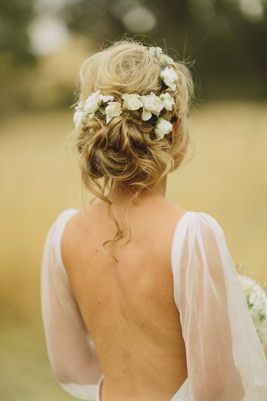simple low bun updo with a pearl hairpiece