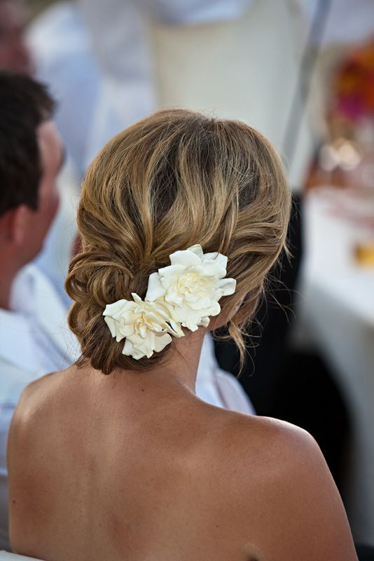 side swept braided updo with big white blooms