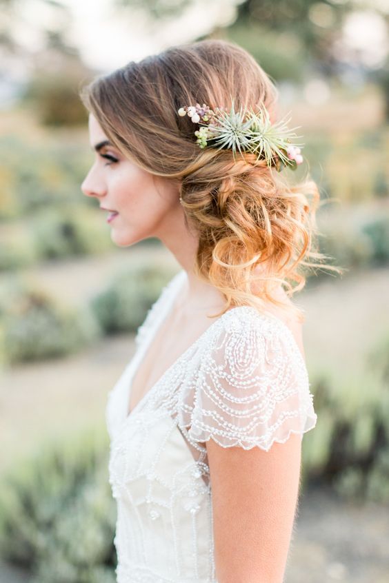 a romantic and elegant curly side updo with a volume on top is a nice match to your vintage-inspired bridal outfit
