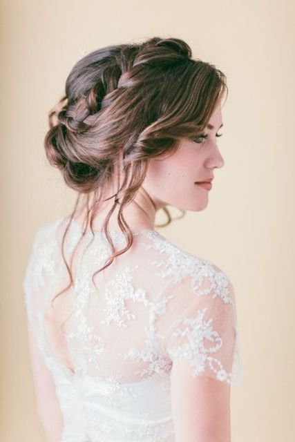 wavy hair pulled up into a braided wedding hairstyle