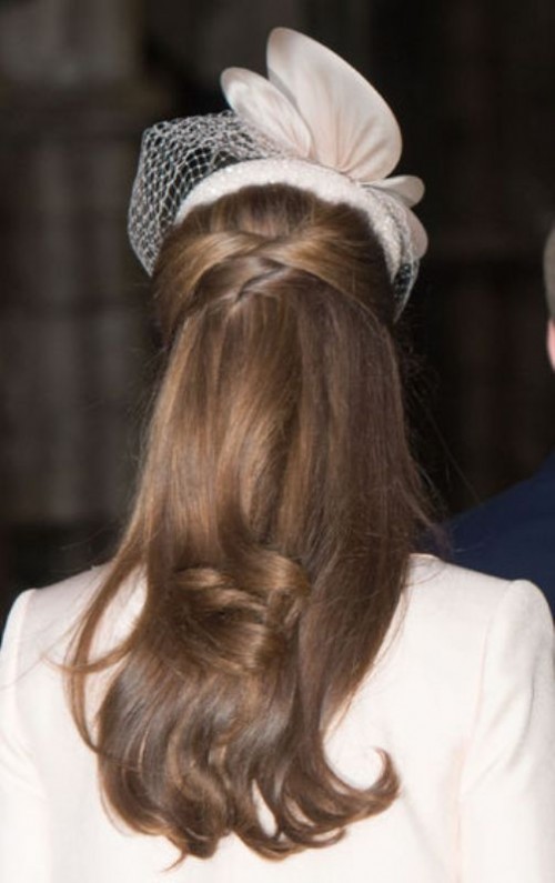 a girlish wedding hairstyle with a twisted front, a volume on top and waves down looks chic and stylish