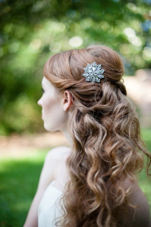 a refined half updo with a volume on top, curls, waves down is an elegant and chic idea