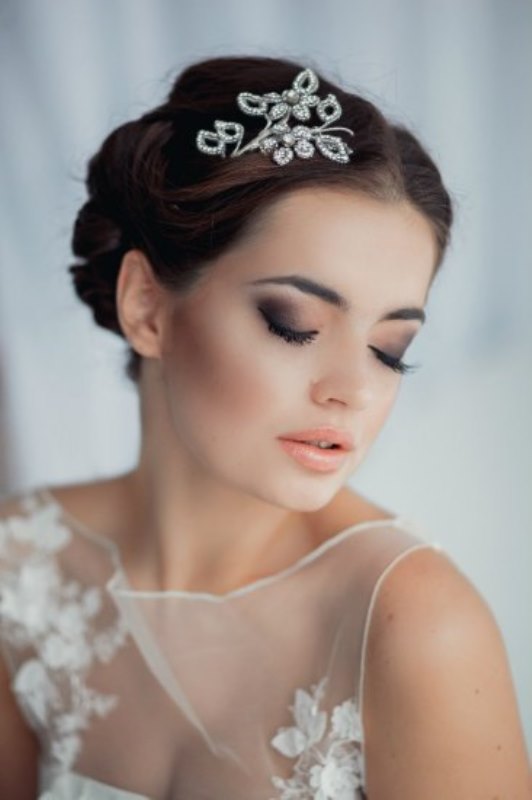 a low updo with a bump and a twisted bottom plus some locks down looks very refined and vintage-inspired