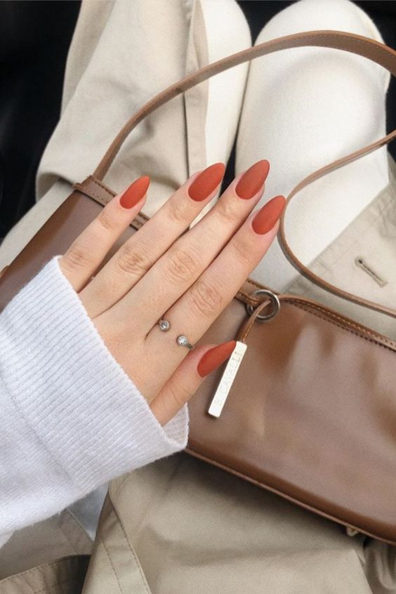matte rust-colored nails and nude ones with botanical patterns are lovely and neutral enough but with a fall twist