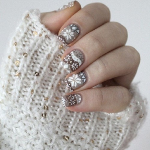 white nails, a pink nail with a snowflake, a silver glitter nail for a bright modern touch to your glam winter bridal look