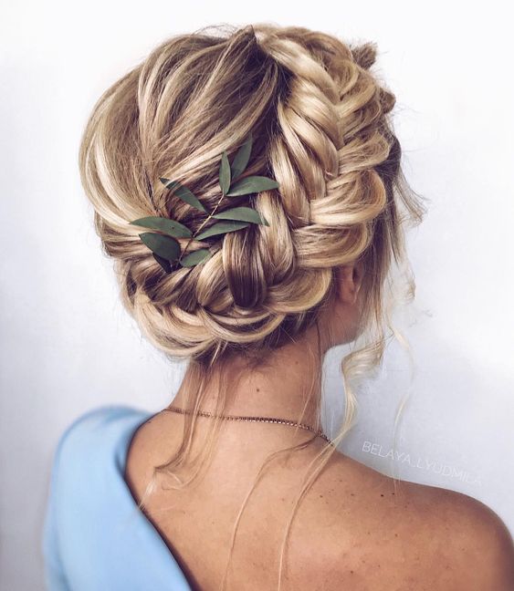 an updo with a fishtail braid on the side and some locks down is a modern and simple idea