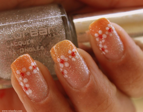 Orange french manicure with flower art and glitter