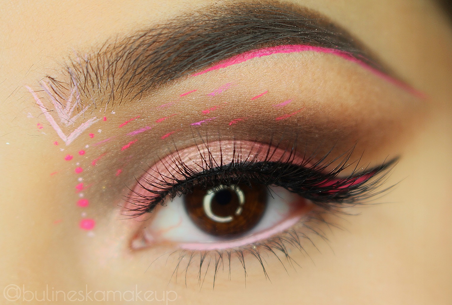 Pink neon wing makeup with neon flecks