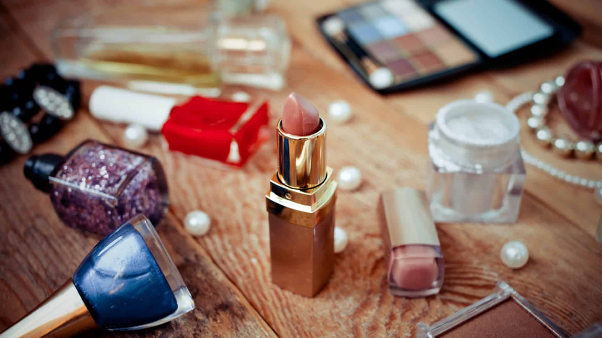 Various makeup products on wooden background