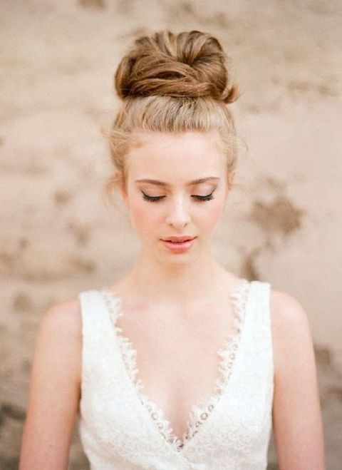 a soft and messy bridal updo looks chic and doesn't require much effort to make
